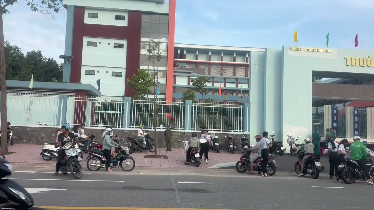 Cổng trường học gần dãy trọ Mỹ Phước 3, phụ huynh đưa đón con bằng xe máy