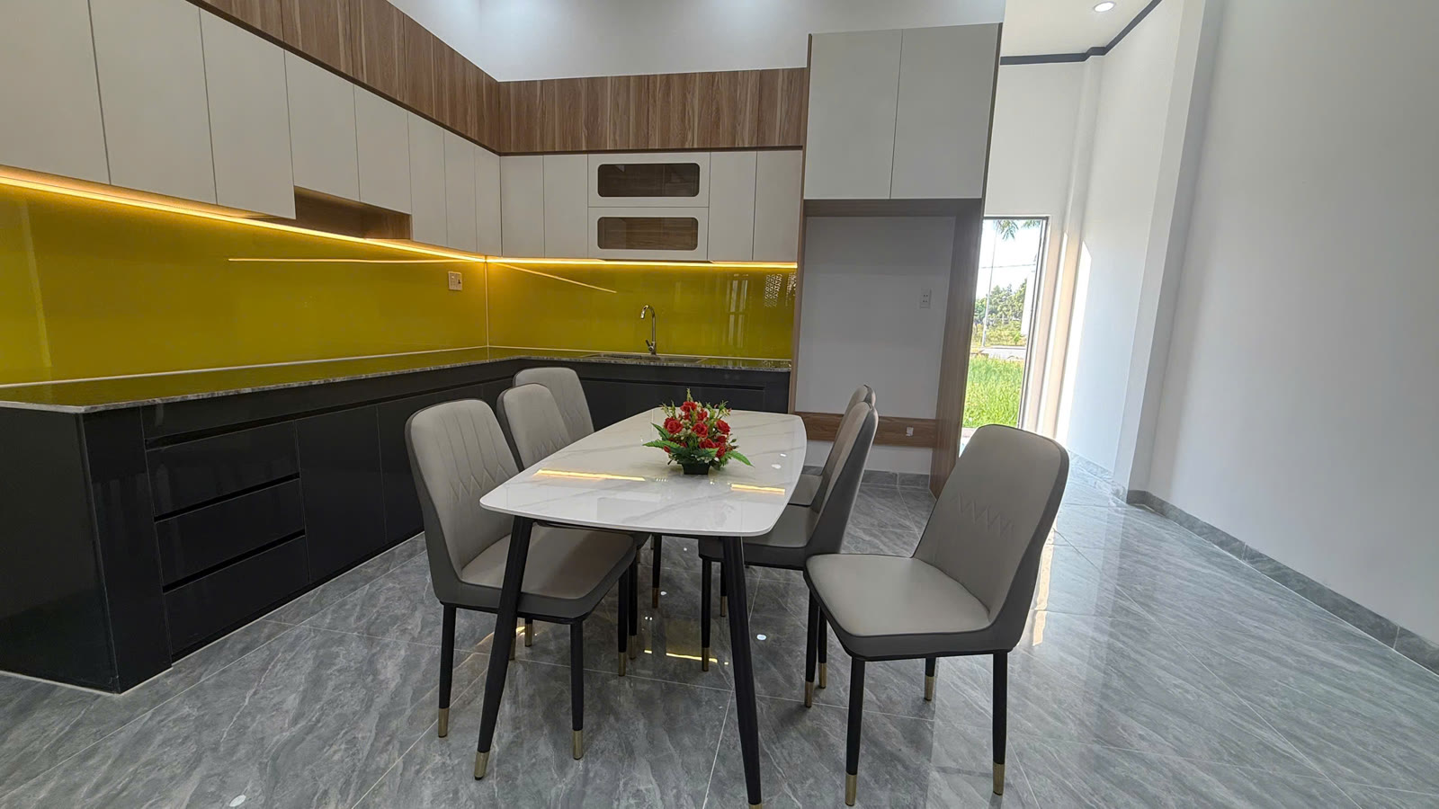 Bếp nhà 1 trệt 1 lầu Mỹ Phước có tủ bếp trên dưới đóng sẵn và bộ bàn ăn 6 ghế