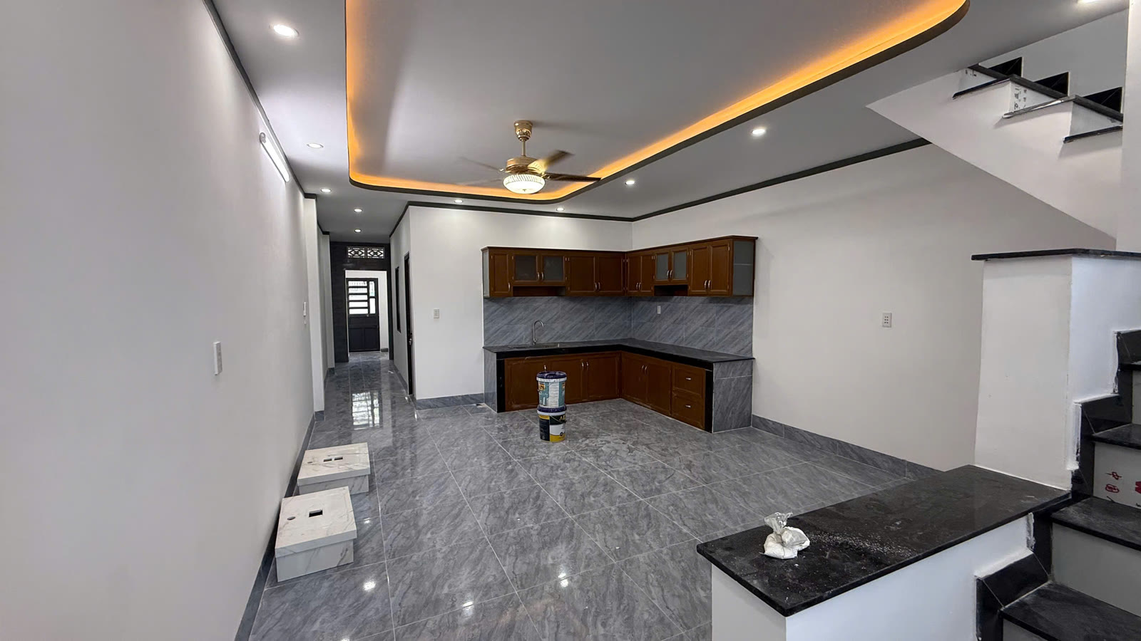 Bếp rộng nhà 5x30 Mỹ Phước 3 với tủ bếp trên và tủ bếp dưới làm sẵn